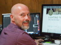 A staff member sitting at a computer