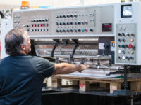 A man works on a press