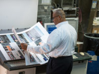 A staff member inspects a proof